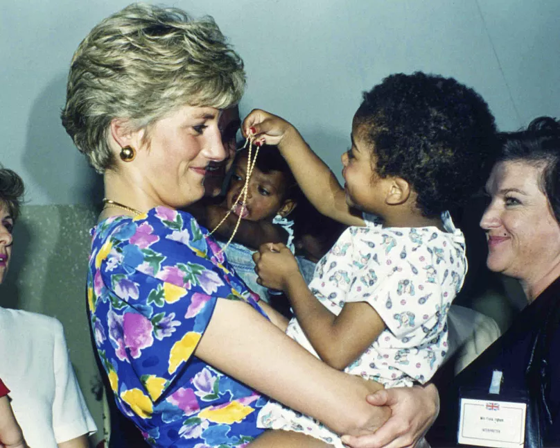 Princess Diana of Wales embraces and plays with an HIV-positive baby at Faban Hostel in São Paulo, Brazil, in 1991. This iconic image challenged the stigma surrounding HIV/AIDS.